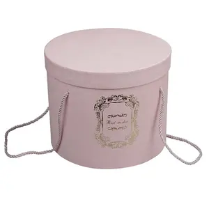 Caja de papel de flores redonda de lujo con tapa y Asa de cuerda Papel de cartón de estampado en caliente dorado Caja de flores rosa/Blanco/Negro portátil