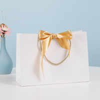Sacs cadeaux de luxe avec nœud papillon pour l'emballage de bougies, vêtements, cosmétiques, sacs fourre-tout avec poignées torsadées, logo imprimé personnalisé