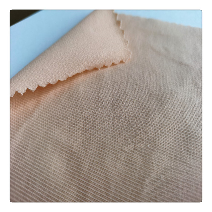 В наличии Дешевые однотонные окрашенные хлопковые нейлоновые тянущиеся ткани для вязания светло-розовые трикотажные ткани для женщин