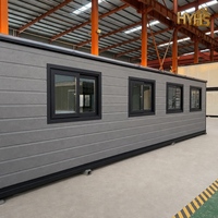 Maison conteneur moderne extensible de luxe de 40 pieds avec cadre noir, caractéristiques imperméables et résistantes au vent, idéale pour hôtel ou bureau