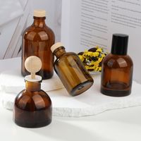 Bouteille diffuseur de parfum en verre plat rond décoratif 100ml 150ml, transparente ou ambrée, vide, pour arômes, MOQ 200 pièces, avec bouchon couronne.