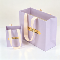 Fournisseur de sacs en papier violet clair personnalisés de luxe avec poignées en ruban pour cosmétiques, lotions, maquillage, rouges à lèvres, perruques, cadeaux et shopping
