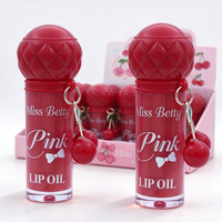 Vente en gros d'huile à lèvres rose très prisée avec breloque cerise, ensemble de porte-clés huile à lèvres portable mignon, style cerise, coffret cadeau pour le soin quotidien des lèvres