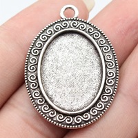 Pendentif plateau ovale à bordure nuageuse bouclée en alliage de zinc bronze antique, avec monture pour cabochon, pour locket vintage et artisanat de portrait