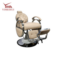 Fauteuil de barbier inclinable robuste de style rétro, en cuir capitonné beige, avec structure en métal poli, rotation à 360°