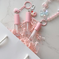 Tube à gloss transparent vide avec un grand pinceau et une chaîne d'accessoires en forme de cœur, contenant à gloss
