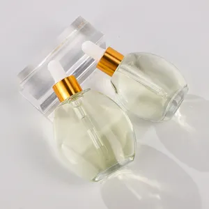 Flacon compte-gouttes en verre de forme ovale de 30ml au design personnalisé avec verre haut de gamme flacon d'huile essentielle pour huile corporelle parfum cheveux