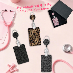 Manufacturer of leopard print epoxy rotating pull <b>buckle</b> 360-degree badge/ID card roll <b>clip</b> with detachable webbing lanyard - Product Image 1