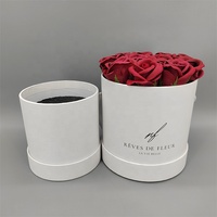 Rose éternelle blanche très vendue pour la Saint-Valentin dans un coffret cadeau rond en carton recyclé avec revêtement UV et logo personnalisé