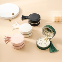 Luxueux moderne Mini ronde en cuir PU Portable fermeture à glissière boîte à bijoux de voyage avec gland