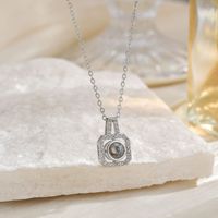 Collier pendentif en zircon en forme de cœur avec projection 100 langues, design de niche pour femme, bambou tendance, cuivre mat, Europe Amérique