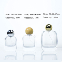 Flacon de parfum en verre transparent rond de luxe 30 ml 50 ml avec boîte et sac, impression et gravure personnalisables