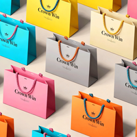Vente en gros de sacs à provisions imprimés personnalisés sac cadeau avec logo de marque sac en papier de luxe avec poignée de vêtements de promotion pour les petites entreprises