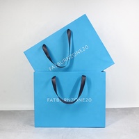 Emballage de cadeau de bijoux de mode personnalisé vêtements sacs en papier bleus à provisions avec logo