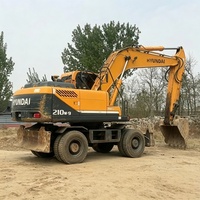 Excavatrice sur pneus Hyundai 210 d'occasion, modèle 2024, très populaire et très demandée, avec moteur Cummins, pompe hydraulique Kawasaki, moteur, engrenage et contrôle PLC