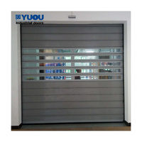 Puerta enrollable espiral industrial duradera con panel sándwich de aluminio reforzado aislado y operación automática, puerta rá