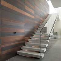 Conception moderne d'escaliers flottants en forme de u avec rail en verre, intérieur en acier à double brin de haute qualité