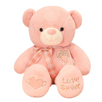 Ours en peluche doux et câlin avec broderie en forme de cœur pour un cadeau de la Saint-Valentin