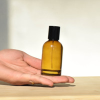Botella de Perfume Redonda de Vidrio Vacía de Lujo al por Mayor de 30ml 50ml 100ml con Pulverizador y Tapa Negra Ámbar con Logotipo Personalizado por Estampado en Caliente