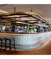 Ensemble de bar en forme de L en surface solide Corian avec design de façade perlée et éclairée, idéal pour les bars extérieurs, les bars domestiques et les sous-sols