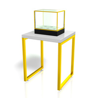 Table de présentation en verre avec cadre en métal jaune, plateau blanc, base noire, stand de vente de bijoux