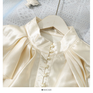 เสื้อผู้หญิงแฟชั่นฤดูร้อน แขนบานเงา ทรงหลวม สีพื้น แต่งระบาย คอตั้ง ติดกระดุมแถวเดียว - Product Image 4