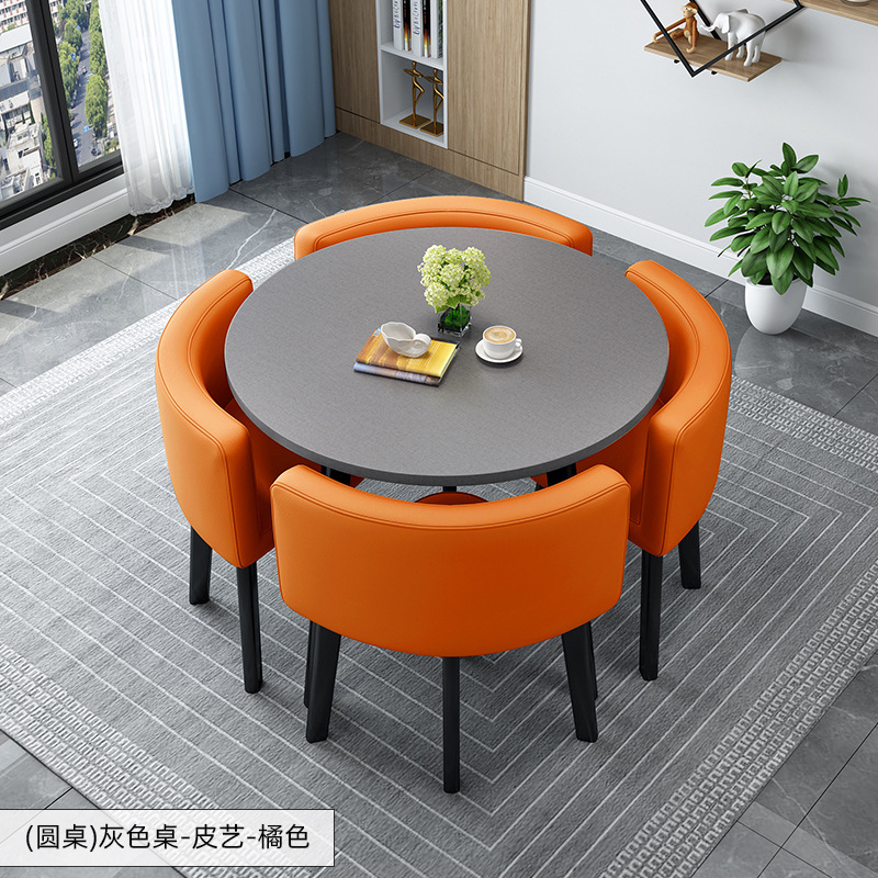 Tavolo rotondo grigio + sedia in pelle arancione