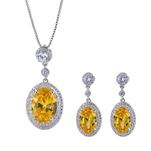 Venta al por mayor de fábrica: Conjunto de pendientes y collar de circonita cúbica amarilla de 8*12mm con engaste ovalado chapado en oro y cobre, ecológico y de moda. - Product Image 1