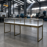 Vitrine à bijoux autoportante en verre avec cadre noir, pieds hauts et éclairage LED pour les bijouteries professionnelles
