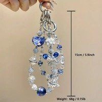 Breloque de téléphone papillon bleu en strass et perles, pendentif de sac artisanal lourd, cordon de poignet, cadeau bijou pour femme