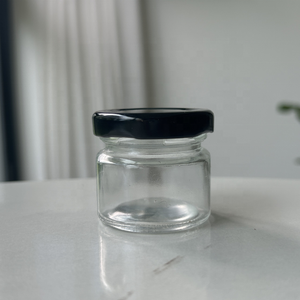 Bon marché, petit <span class=keywords><strong>pot</strong></span> <span class=keywords><strong>de</strong></span> nourriture en verre clair rond <span class=keywords><strong>de</strong></span> 25 ml pour mariage, bougie au <span class=keywords><strong>miel</strong></span> avec capuchon torsadé noir <span class=keywords><strong>de</strong></span> 43 mm - Product Image 1
