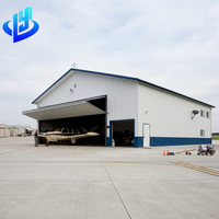Hangar d'avion préfabriqué en structure acier à grande portée, sur mesure, pour le stockage de jets privés