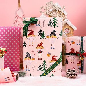 Papel de regalo de Navidad de doble cara rosa con diseño de gnomos de patas largas, bastones navideños y caramelos, en papel estampado. - Product Image 4