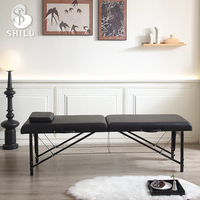 Table de massage pliable portable professionnelle haut de gamme noire en synthétique pour salon de beauté, spa et gymnase - Vente en gros