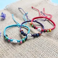 Bracelet unisexe artisanal Dk Bali réglable avec perles coquillage Œil de Shiva et pompon macramé, style décontracté/sportif, pour la mode unisexe