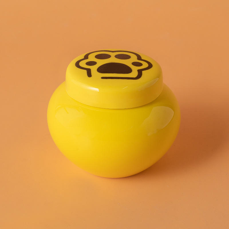 Round ash urn-yellow-black paw print