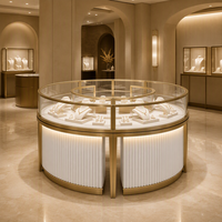Comptoir d'exposition de bijoux rond sur mesure avec cadre doré, corps cannelé et vitrine en verre pour la vente en gros aux bijouteries