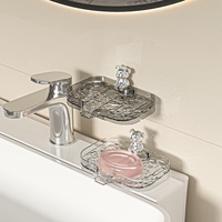 Support mural transparent en plastique sans perçage pour savon, design compact et luxueux, idéal pour petite salle de bain, lavabo ou robinet, pour le rangement quotidien du savon.