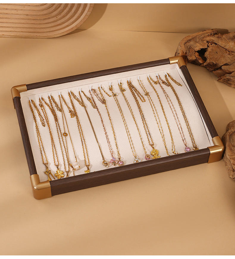 Golden rounded necklace tray with white lining