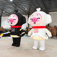 Costume de mascotte cochon noir et blanc gonflable personnalisé pour événements publicitaires, avec ventilateur intégré