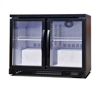 Réfrigérateur minibar à double zone de température pour hôtel, avec porte en verre trempé, adapté au réfrigération des boissons.