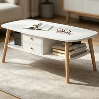 Table basse ovale double couche peu encombrante avec tiroir fermé et étagère ouverte, taille compacte pour salon familial de petite taille