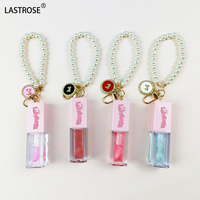 Nouveau design de soins rose dodu à base d'huile pour les lèvres filles fruits liquide brillant à lèvres baume à lèvres huile avec porte-clés
