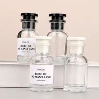 Flacon de parfum rond en verre avec vaporisateur 30ml 50ml 100ml, distributeur d'échantillons vide portable haut de gamme pour voyage avec diffuseur à bâtonnets