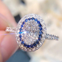 CAOSHI Design Argent Revêtement Ovale Coupe Grand Zircon Bague De Luxe Pierre Bleue Bague De Promesse De Mariée Femmes