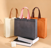 Sacs non tissés écologiques, durables et réutilisables avec poignées en tissu aux tons pastel attrayants pour le branding des magasins de vêtements