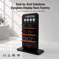 Présentoir vertical intelligent noir à 3 niveaux pour lunettes, avec étagères à accents orange, panneau arrière à motifs, empreinte compacte, pour comptoir