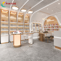 Solution tout-en-un pour boutique de soins de la peau de luxe, présentoirs de magasin de cosmétiques blancs et dorés, design d'intérieur de magasin de cosmétiques, table de consultation pour maquillage