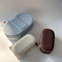 Boîte à bijoux de voyage ovale en cuir PU vegan grainé avec fermeture éclair dorée, mini, personnalisable avec logo et couleur