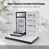 Présentoir à lunettes moderne personnalisé noir et blanc multi-zones en acrylique avec miroir intégré pour essayage et panneau d'affichage interchangeable